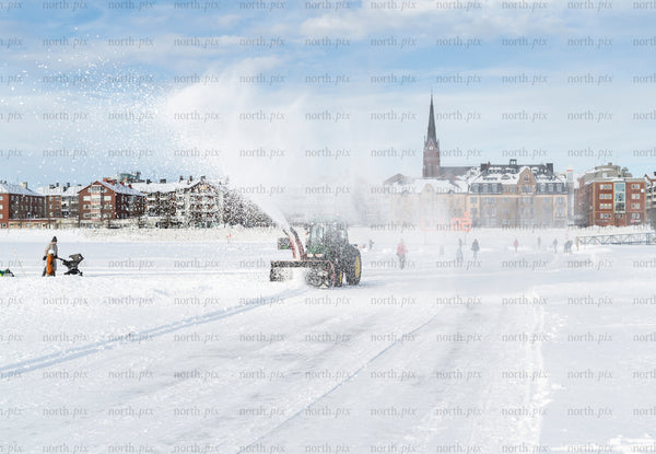 Tractor snow plow on frozen sea ice, Luleå winter