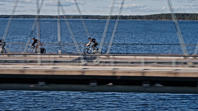 Cyclists on Bergnäsbron bridge, Luleå, summer day, active lifestyle