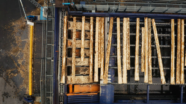 Aerial view of logs being processed at a lumber mill