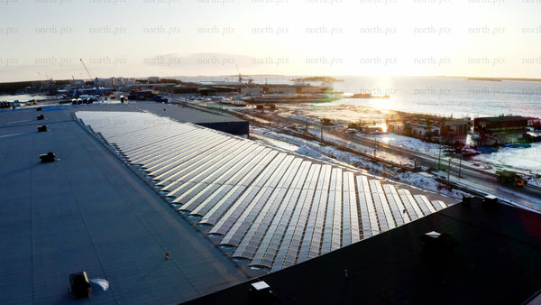 Aerial view of solar panels on rooftop at sunset in winter, Haraholmen, Scandinavia