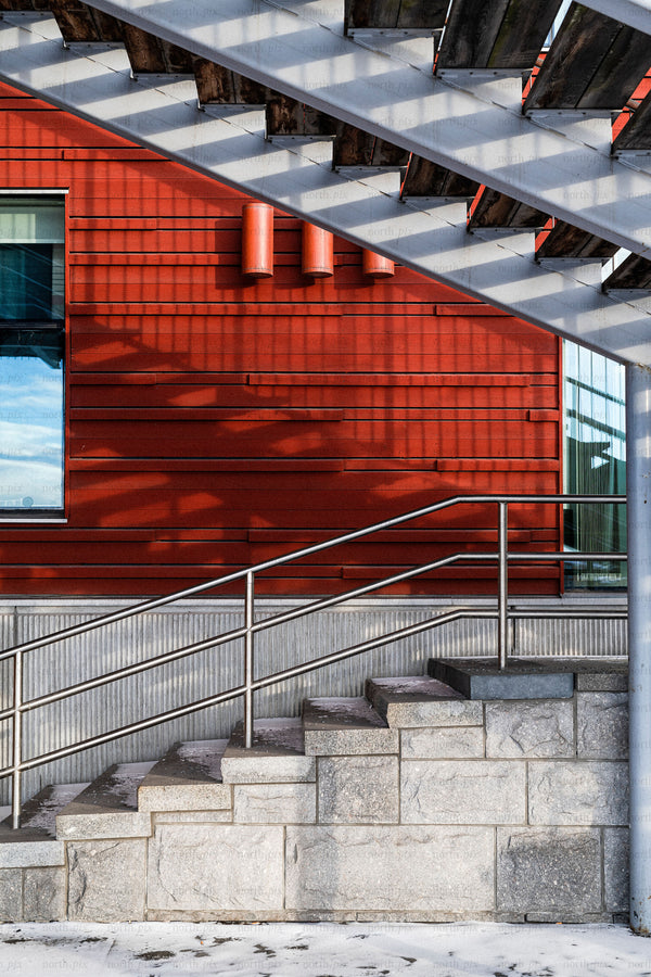 Staircase and red building exterior with metal railing