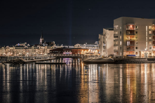 Waterfront apartment buildings and marina at night