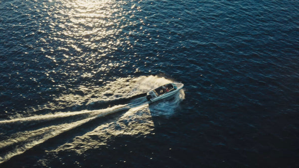 Summer boat trip: Motorboat in the Luleå archipelago at golden hour