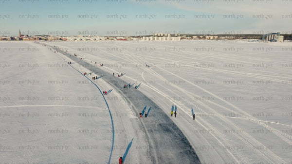 Winter in Luleå: Aerial view of people enjoying a frozen river on a sunny day