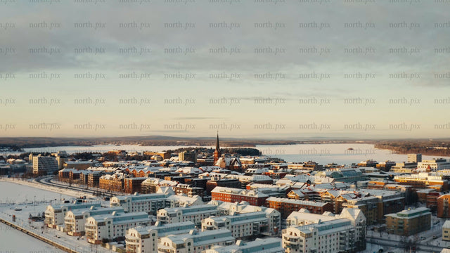 Winter sunrise over Luleå: Aerial drone footage of snow-covered city