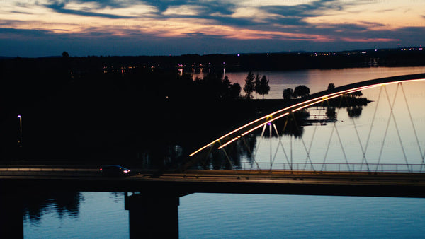 Aerial sunset view of car on Bergnäsbron bridge in Luleå