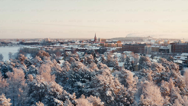 Winter wonderland: Aerial view of snow-covered Luleå at sunset