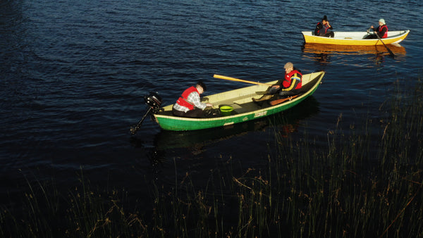 Summer evening on a Swedish lake: Two boats gently floating at twilight