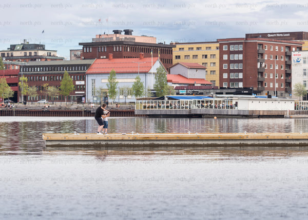 Two people on a dock in Luleå in summer