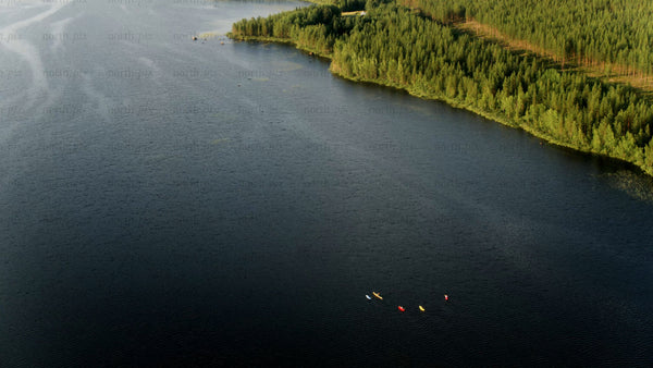 Kayakers on a summer day in Luleå: A drone's eye view of lake and forest