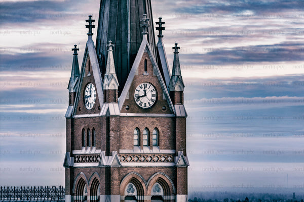 Historic church clock tower against winter sky