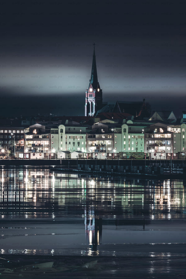 Night view of church and waterfront buildings