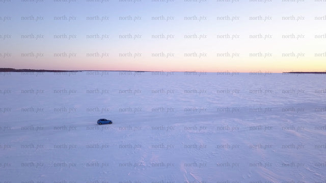 Driving on frozen ice road in lövskär archipelago at sunset