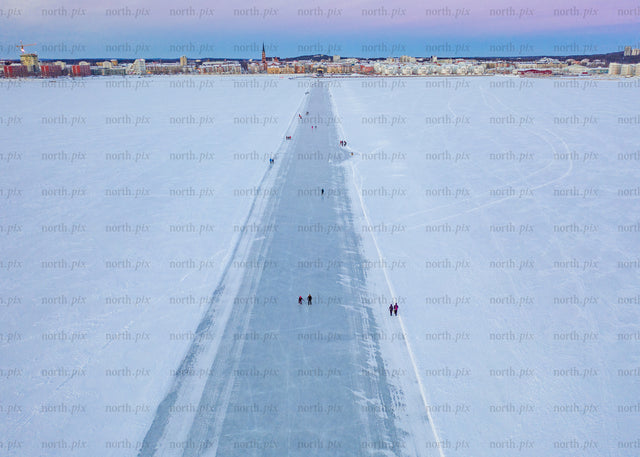 Drone view of winter ice path in Luleå during blue hour