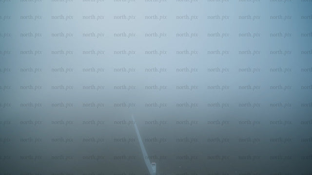 Wind turbine emerging from fog: Aerial view of renewable energy in Haraholmen