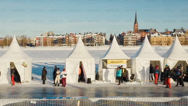 Winter day in Luleå: People gather by tents on a frozen lake