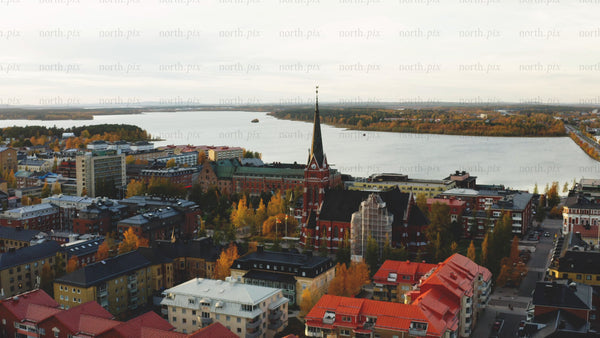 Aerial view of Luleå in autumn: Colorful foliage and Luleå cathedral
