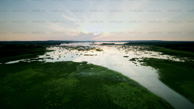 Sunset over calm lake: Aerial view of summer landscape
