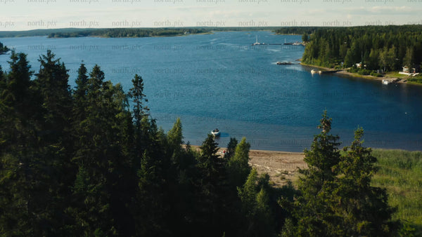 Summer in Luleå Archipelago: Drone View of Boat, Beach, and Forest