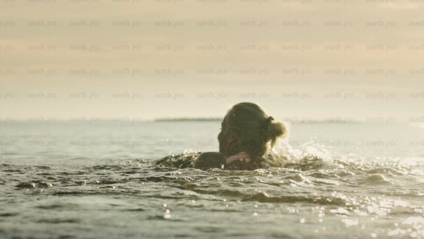 Woman swimming in the Baltic Sea, Luleå archipelago, summer