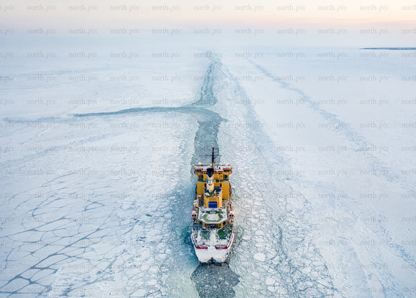 Icebreaker ship navigating arctic waters during winter morning