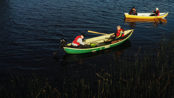 Summer evening on a Swedish lake: Two boats gently floating at twilight