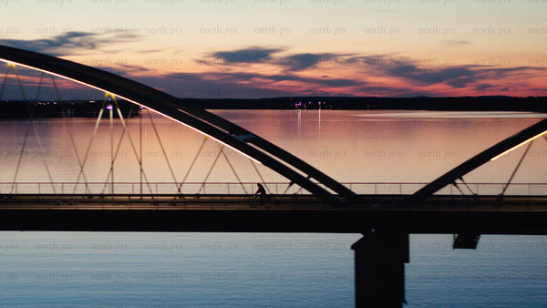 Sunset bike ride across Luleå bridge: An aerial view of summer