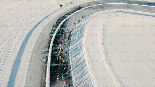 Drone view of ice skating marathon on frozen lake in Luleå