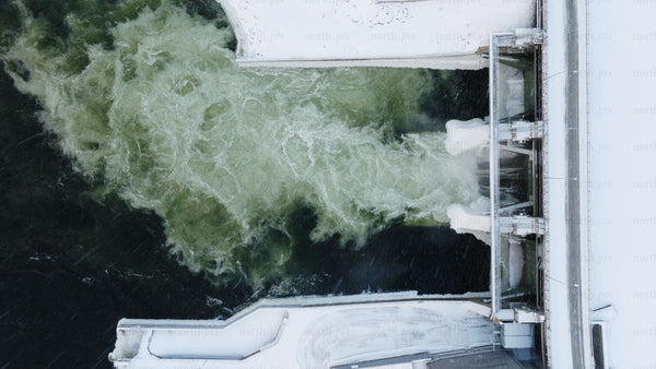 Hydroelectric dam water flow: Aerial view of renewable energy in winter