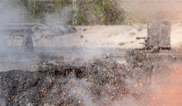 Sparks and smoke in park during daytime