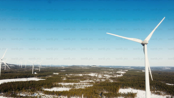 Wind turbine generating clean energy in a snowy winter landscape