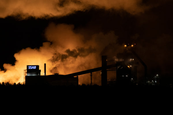 SSAB steel plant exterior at night with smoke