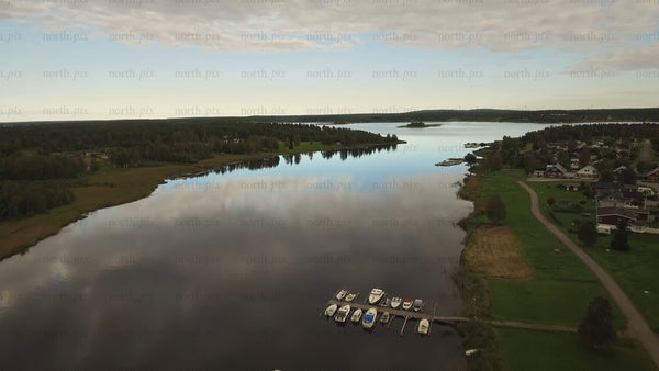 Fårön island, Piteå archipelago: Aerial landscape with forests, calm waters, and boats