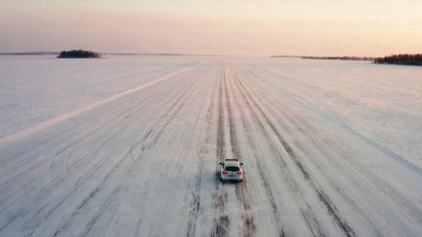 Driving on ice road in lövskär archipelago at sunset, Luleå