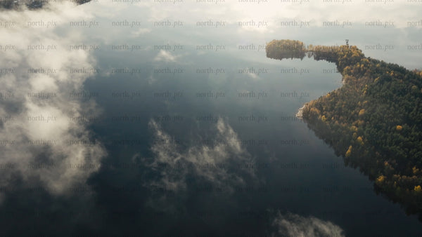 Misty lake and autumn forest at sunrise