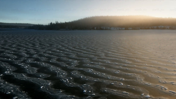 Sunrise over a frozen lake in arvidsjaur, winter landscape