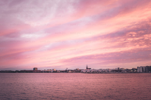 Harbor skyline with church spire at sunset
