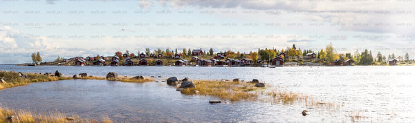 Brändöskär panorama - red cottages along rocky shoreline in autumn