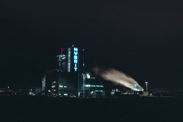 Industrial plant with HYBRIT sign at night