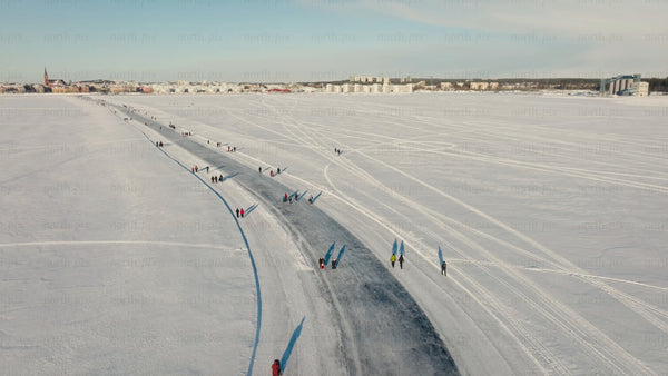 Winter in Luleå: Aerial view of people enjoying a frozen river on a sunny day