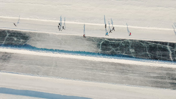 Winter ice skating on frozen river in Luleå - aerial drone view