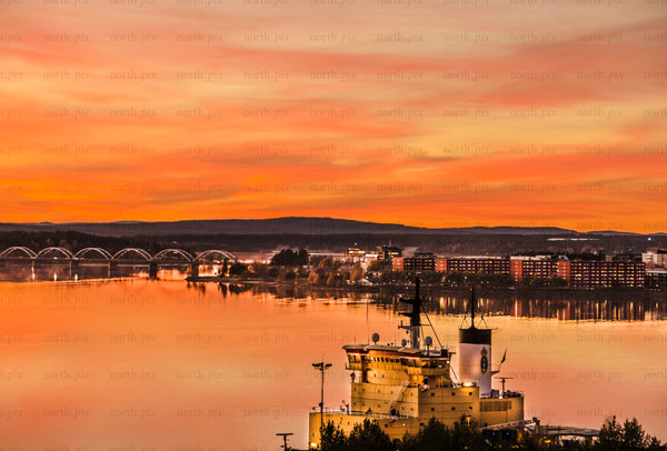 Icebreaker in harbor with bridge and city skyline