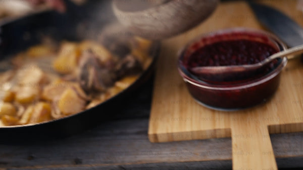 Serving hot reindeer meat and potatoes outdoors in winter, Luleå