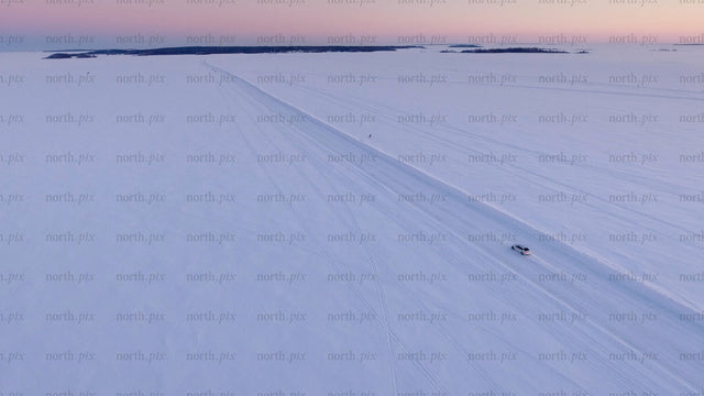 Driving on a frozen ice road at sunset in the Luleå archipelago