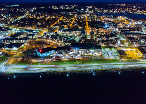 Drone aerial view of Luleå at night during blue hour in autumn
