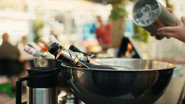 Cooling drinks in ice bucket at an outdoor summer party in Luleå