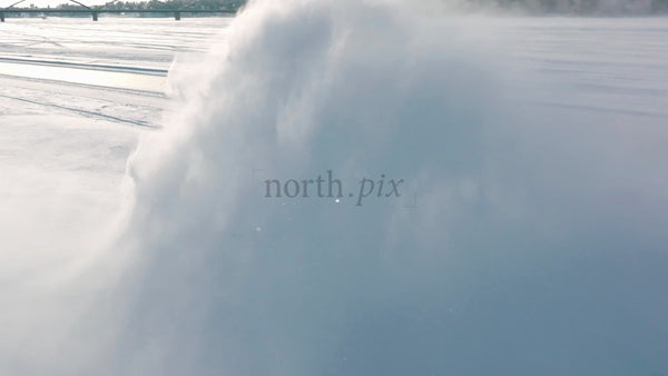 Tractor Clearing Snow on Frozen Lake in Winter, Lulea, Sweden - Aerial Drone Footage