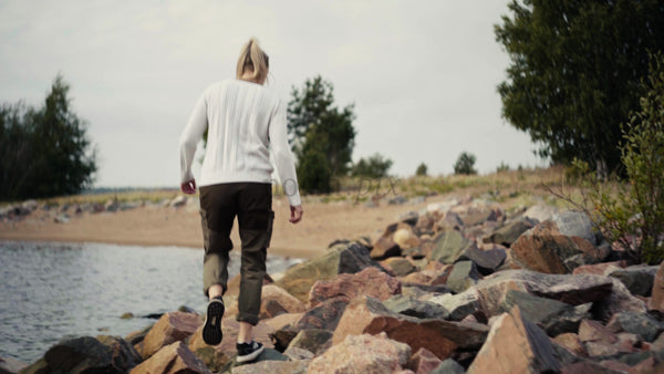 Woman Walks on Rocks by the Water in Luleå Archipelago on a Summer Day