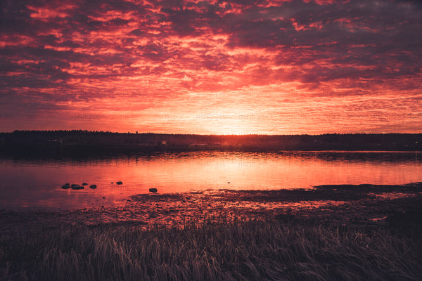 Sunset over a lake with reflected cloud cover