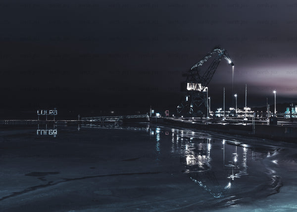 Luleå industrial harbor crane at night with reflections